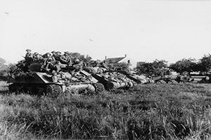 Infantry on a Sherman tank near Ranville