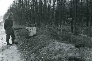 Browse A soldier pauses by temporary graves