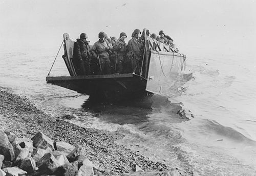 A platoon of American troops land from a naval LCVP