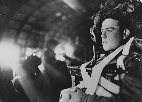 A paratrooper seated in a Dakota aircraft