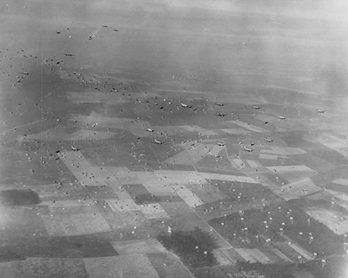 Paratroopers drop from C-47 transport planes