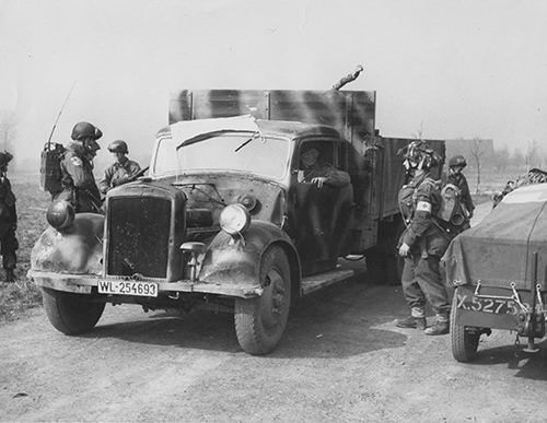 Airborne troops with a requistioned German truck