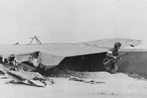 A US soldier rushes from a torn glider