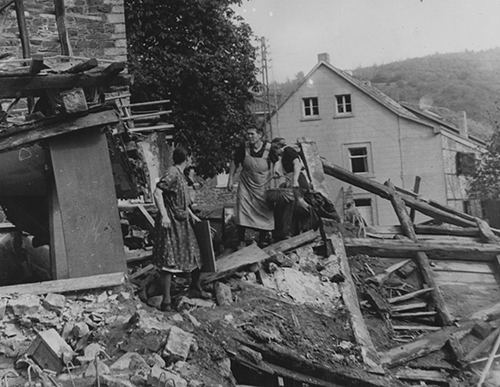 German women search the wreckage of their homes