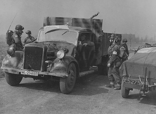 Airborne troops with a requistioned German truck