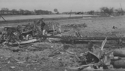 Burnt out wreck of a lashed down jeep