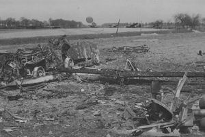 Burnt out wreck of a lashed down jeep