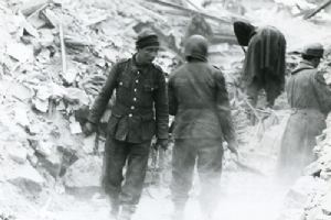 Browse German prisoners help men of the 3rd Tank Battalion