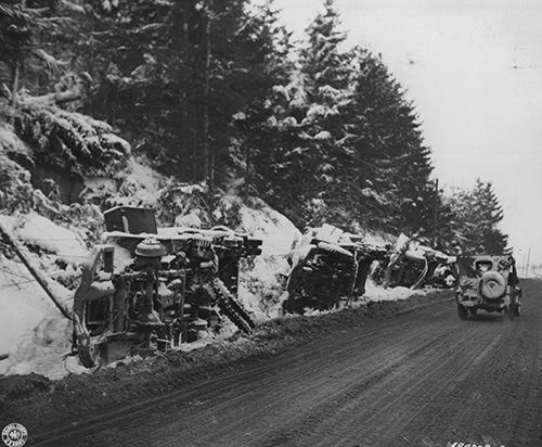 American and German Vehicles lay on a roadside