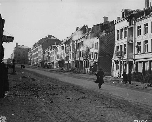 Enemy shellfire lands on a building in Bastogne