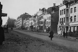 Enemy shellfire lands on a building in Bastogne