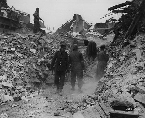 German prisoners help men of the 3rd Tank Battalion