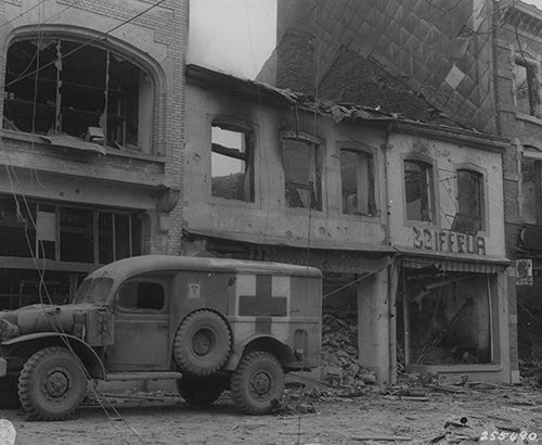 American ambulance waits outside a bombed building