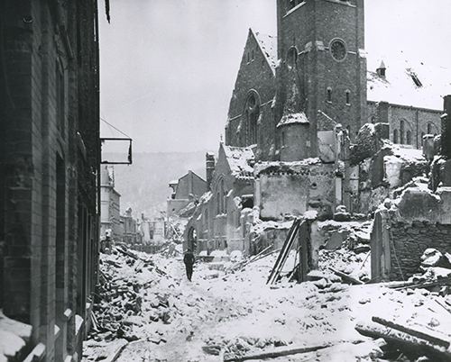 A civilian picks his way through the rubble