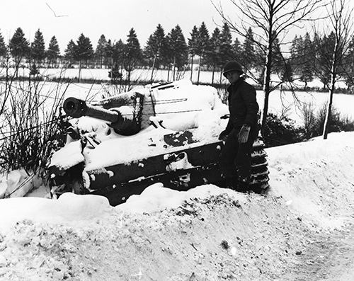 US soldier inspects a knocked out Tiger tank