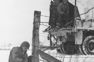 Browse A member of the 4th Armoured Div laying wire