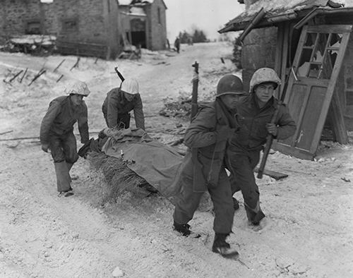 A patrol from 30th Division rescue an injured German soldier