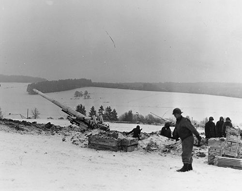 Two 155mm 'Long Tom' Howitzers shell German positions east of Bastogne