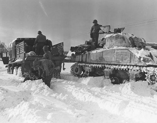 Members of 7th Armoured Division fuel their tank at Walmaz