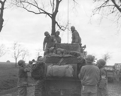 Tanks of the 4th Armoured Division bring back casualties