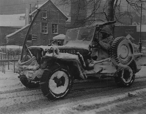 30th Division jeep moving through the streets of Malmedy