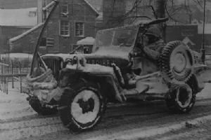 Browse 30th Division jeep moving through the streets of Malmedy