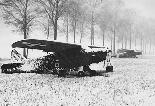 An artillery observation plane under camouflage netting