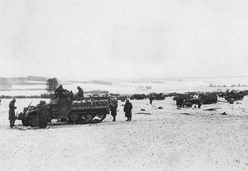 Half-tracks of the 4th Division wait to advance