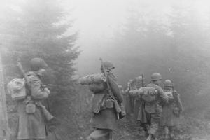 Browse American soldiers advance through the forest of Ardennes