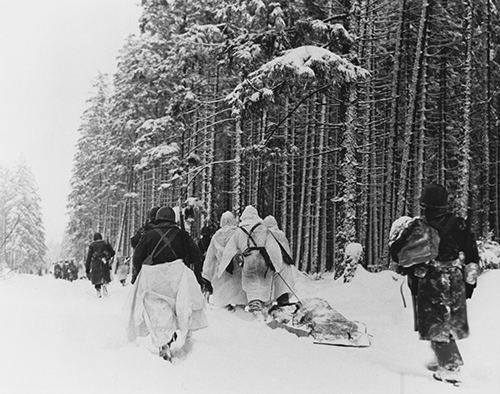 American troops drag a heavily loaded ammunition sled