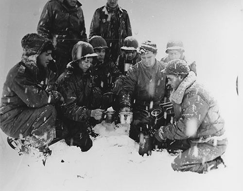 Soldiers heat coffee with a blowtorch