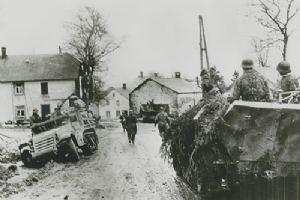 Browse Waffen-SS Panzergrenadiers move past wrecked American truck