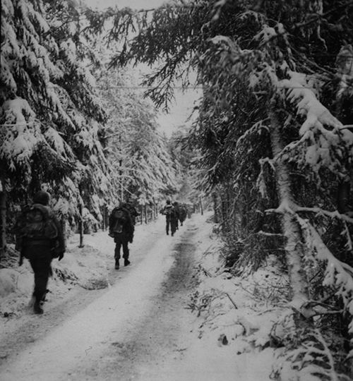 American infantry move up over a snow covered road