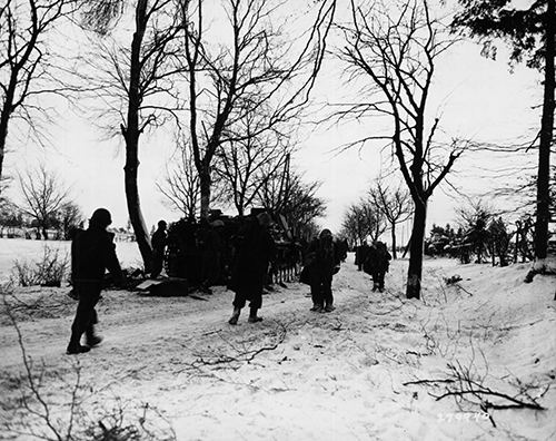 Troops of the 7th Armored Division look over an undamaged German tank