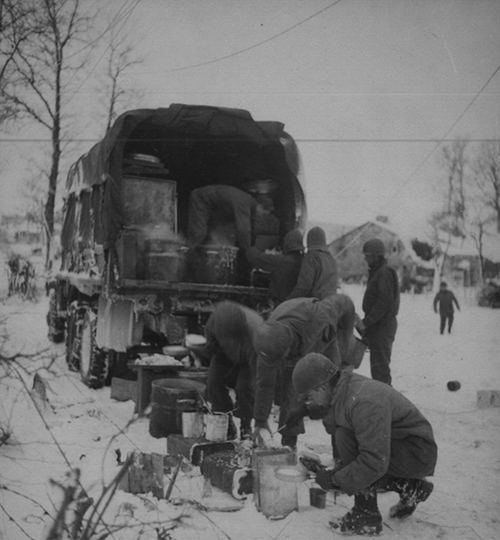 Chow is served to soldiers amid the snow