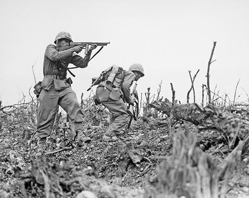 Two U.S. Marines advance on Wana Ridge